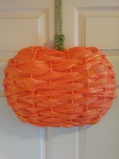 an orange pumpkin hanging on the front door