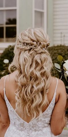 the back of a woman's head wearing a wedding dress