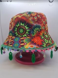 a colorful hat is sitting on top of a stand