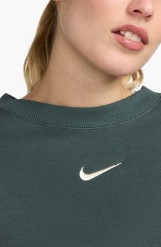 An embroidered Swoosh adds minimal branding to this cozy fleece sweatshirt cut for a relaxed, oversized fit that's enhanced by the dropped shoulders. 22" length (size Medium) Crewneck 80% cotton, 20% polyester Machine wash, tumble dry Imported Nike Green Sweatshirt, Nike Green Athleisure Sweatshirt, Green Nike Vintage Sweatshirt, Nike Phoenix Fleece Sweatshirt, Nike Moisture-wicking Outdoor Sweatshirt, Minimal Branding, Cut Sweatshirts, Oversized Fits, Crew Neck Sweatshirt