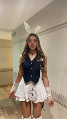 a woman dressed up as a bunny with white stockings and knee high boots, holding a clock in her hand