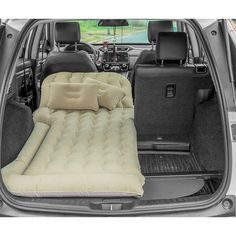 an inflatable mattress is placed inside the trunk of a car