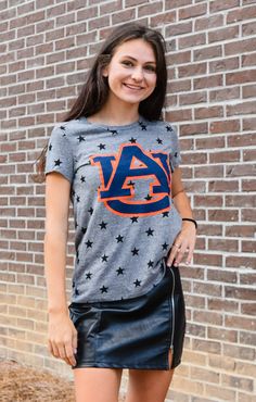 You'll be the "star" of the tailgate in our Auburn Superstar tee! This unique tee features the Auburn logo with a background of black stars on a grey tee. It's the perfect top to wear on gameday or just walking around campus! Pair it with ripped jeans or denim shorts, and your favorite pair of sneakers for a perfect look! Details: *OFFICIALLY LICENSED* Crew Neckline Short Sleeve Relaxed Fit Color: Heather Grey with Black Stars Fabrication: 50% polyester, 38% Cotton, 12% Rayon Natalee is wearing Auburn Logo, Black Stars, Sarasota Florida, Auburn Tigers, Grey Tee, New Mothers, Trendy Clothes For Women, Southern Style, Black Star