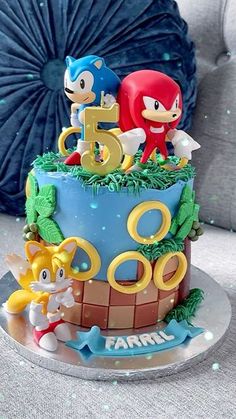 a sonic the hedgehog themed birthday cake with figurines and decorations on top