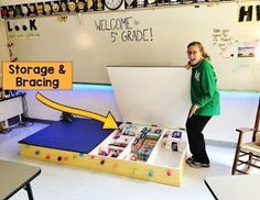 a woman standing in front of a large cardboard box with magnets on the inside