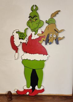 an image of the grinch from the grinch movie cut out on a wall