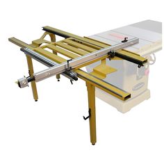 a table sawing machine on top of a white box with yellow handles and wheels