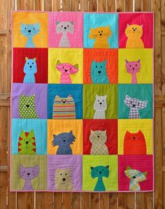 a colorful quilt with many cats on it