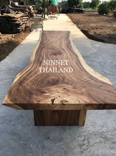 a wooden bench sitting on top of a cement ground