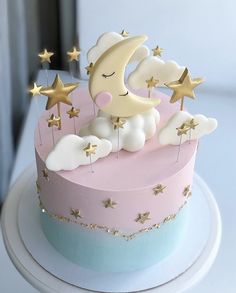 a cake decorated with stars and a moon on top