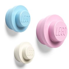 three different colored knobs with the word lego written on them in white, blue, and pink