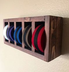 a wooden rack with hats hanging from it's sides