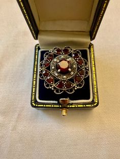 EXCEPTIONAL VINTAGE HUGE AUSTRO-HUNGARIAN STERLING SILVER RING, DECORATED WITH 13 GARNETS AND 8 FINE PEARLS. ALL STONES ARE GENUINE. VERY FINE JEWELRY, MAGNIFICENT VERY ORGANIZED DESIGN. IMPOSING LUXURIOUS MODEL, VERY BEAUTIFUL ELEGANT EFFECT. 12 SUPERB ROUND NATURAL GARNETS: 3 mm. A CENTRAL GARNET: 6 mm. 8 FINE PEARLS. RING PLATE DIAMETER: 24 mm. WEIGHT: 6.3 gr. HALLMARK: 925. FRENCH SIZE: 54. US SIZE: 6 3/4. IN VERY GOOD SHAPE. BOX NOT INCLUDED. Pearls Ring, Huge Rings, Ring Luxury, Ring Plate, Silver Jewels, Seed Pearl, Hallmark, Luxury Design, Garnet