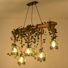 a chandelier made out of mason jars with ivy growing on the top and bottom