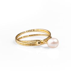 Minimalist Pearl & Gold Elegant Cocktail Ring. Featuring a 24k gold-plated brass band in a sleek, minimalist wrap design, this ring is adorned with a delicate, small pearl that appears to float gracefully. Its refined and unique style adds a touch of sophistication to any outfit, making it the perfect accessory for those who love understated yet chic jewelry. Whether worn alone or stacked, this ring exudes elegance for any occasion. Details Crafted with high-quality brass and plated with 24k gold for a luxurious finish. Pearl stone Adjustable size Avoid contact with chemicals, makeup, perfume. Do not use dips or abrasive cleaners on ring. To clean and brighten it up your ring, wipe them gently with jewelry polishing cloth. September Birthstone Jewelry, Pearl Stone, Brass Band, Artisan Gift, Zodiac Jewelry, Jewelry Ring Box, Outfit Making, Men's Jewelry Rings, Chic Jewelry