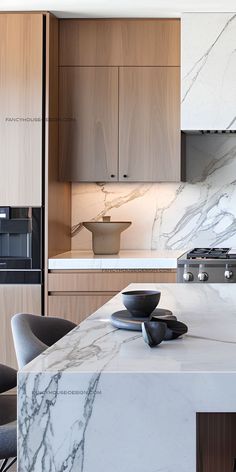 a kitchen with marble counter tops and wooden cabinetry, along with black leather chairs