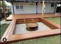 a wooden deck with a fire pit in the middle