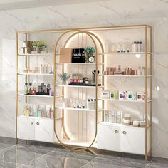 a white and gold display case in a room with marble flooring, shelves filled with personal care products