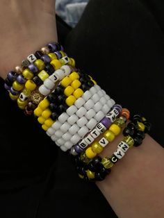 the bracelets are decorated with beads and letters