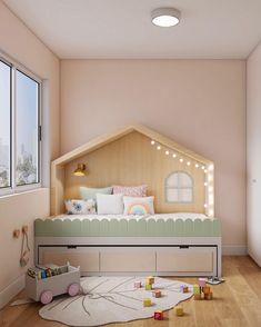 a child's bedroom with pink walls and wooden flooring, including a bed