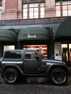 a black jeep parked in front of a store