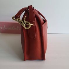 "Vtg Coach Original Companion Bag Red leather with anchor stamp brass hardware Roomy interior with slip pocket Secured by a top Talon Zipper Two front slip pockets Hang tag and ball chain Removable 33.5\" strap Measures: 11\"L, 7.5\"H, 2.5\"W Made in New York City, USA #092-2605 Flaw: discoloration on zipper pull (typical from age) Cleaned, conditioned and ready to wear! Questions? Just ask! More vtg Coach styles/colors available G68a" Red Coach Shoulder Bag With Adjustable Strap, Red Coach Shoulder Bag With Branded Hardware, Vintage Coach Bags Red, Coach Red Bags With Leather Handles, Olive Green Top, Red Vintage Shoulder Bag With Gold-tone Hardware, Vintage Coach, Brass Hardware, Tiffany Blue