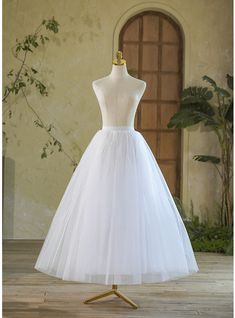 a white wedding dress on a mannequin