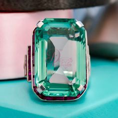 "Specification:- Stone Details :- *Diamond Material: Cubic Zirconia (CZ) *Center Diamond Shape : Emerald Cut *Center Diamond Dimension: 32* 25 MM *Side Diamond Dimension : 2*3.50, 4.50*2.50, 5*2, 6*2 MM *Diamond Color : Green, Pink *Clarity: VVS *Making Process: Handmade by our Experienced Staff. *Stamp: Our All Rings Stamped According to metal Purity (925 SIL/10K/14K/18K). Customization:- *Buyer can Request change of rhodium color in 925 Silver Jewelry (No additional Charge). *In Gold (10K, 14K, 18K) buyer can change gold color (White, Rose, Yellow). *Buyer can also change CZ Stone Color (No additional Charge). Custom Order:- *We do Accept Custom order. *Buyer can also request customization in listed Items (Charges apply according to required Customization). Free Engraving:- *We Provide F Large Cocktail Ring, Wood Resin Jewelry, Diamond Cocktail Ring, Wedding Engagement Ring, Dream Gift, Diamond Cocktail Rings, Filigree Ring, 925 Silver Jewelry, Cz Diamond