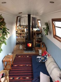 a living room filled with furniture and a fire place in the middle of it's walls