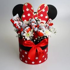 a mickey mouse hat with candy and flowers in it