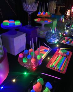 an assortment of colorful desserts on display at a party