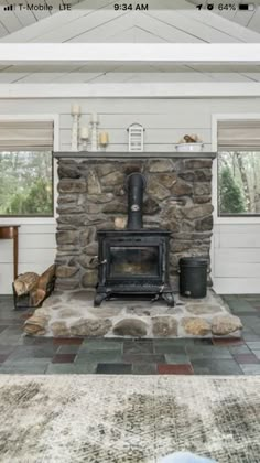 a living room with a stone fireplace in it