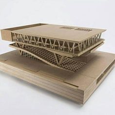 two wooden model buildings sitting on top of each other in front of a white background