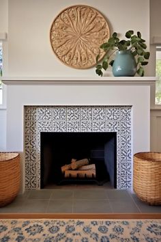 a living room with a fire place and vases on the mantle