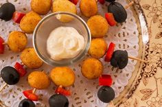 an assortment of appetizers on a plate with toothpicks and dip sauce