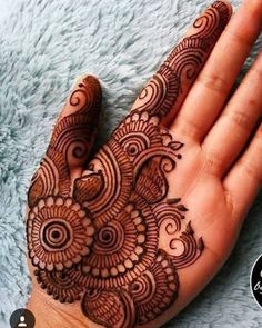 the hand is decorated with henna designs on it