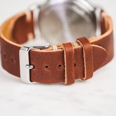 Our classic 2-piece custom watch straps feature Horween Leather in multiple color options with natural stitching. Straps feature a thumbnail style buckle and leather strap stays. As you wear your strap, you will notice how quickly it breaks in and molds to your wrist creating an incredibly comfortable fit. And with daily wear, it will deepen in color and patina becoming a piece completely unique to you.• Handmade watch band in Horween Leather• Simple stitching in Natural waxed polyester thread• Brown Leather Strap For Round Dial Watches, Classic Leather Strap Watch Bands For Everyday Use, Classic Watch Bands With Waxed Finish For Everyday Use, Leather Bracelet Strap For Watch, Everyday Wear, Adjustable Leather Watch With Stainless Steel Clasp, Leather Bracelet Strap For Everyday Watch Use, Leather Bracelet Strap Watch Accessories For Everyday, Timeless Adjustable Leather Watch Band, Leather Watches With Bracelet Strap And Round Dial