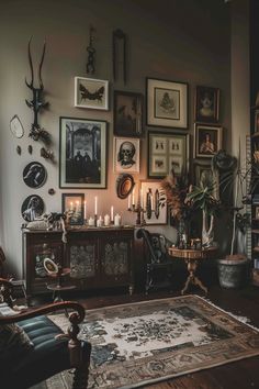 a living room filled with furniture and pictures on the wall next to a rug covered in candles