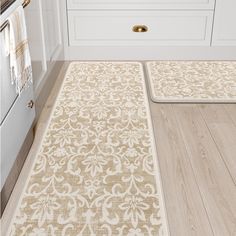 two rugs on the floor in a kitchen