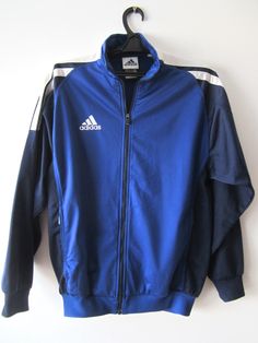 "Vintage Blue Adidas Jacket Blue Adidas Zipper Running Jacket Unisex Jogging Parka Blue Soccer Jacket Three Stripes Size Large Adidas Cardigan Label size: D 176; GB 34/36; F 16A Measurements: (lying flat) Length - 28.5\"/ 72.5 cm Shoulders: 20\"/ 51 cm Pit to pit: 22.5\"/ 57 cm Waist: 19.5\"/ 49.5 cm Sleeve: 22.5\"/ 57 cm Please check measurements to insure a proper fit. Remember to allow yourself some extra room for movement. You can compare these with something from your closet that fits you w Blue Long Sleeve Outerwear With Zipper Closure, Blue Long Sleeve Outerwear With Zipper, Casual Blue Windbreaker With Zipper, Casual Blue Windbreaker With Zipper Closure, Blue Windbreaker With Zipper For Fall, Blue Windbreaker With Zipper Closure For Fall, Blue Zipper Windbreaker For Fall, Winter Blue Windbreaker With Zipper Closure, Blue Zipper Closure Windbreaker For Fall