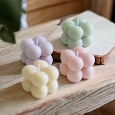 three candles sitting on top of a wooden table