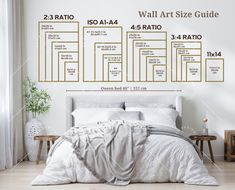 a white bed sitting in a bedroom next to a wall mounted art print on the wall