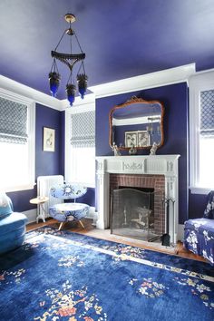 a living room filled with furniture and a fire place in the middle of a room