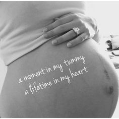 a pregnant woman's belly with the words moment in my tummy, a lifetime in my heart written on it