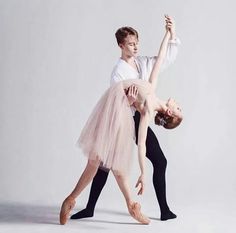 two ballerinas in tutu and leotards posing for a photo together