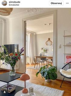 a living room filled with furniture and flowers