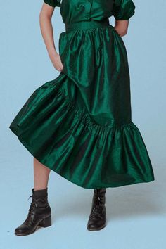 Green Full Skirt For Party, Green Voluminous Tiered Maxi Skirt, Chic Green Tiered Skirt, Green Ruffled Flared Maxi Skirt, Green Lined Maxi Skirt For Fall, Green Flared Maxi Skirt With Ruffles, Chic Green Gathered Skirt, Chic Green Gathered Skirt Bottoms, Fall Green Lined Maxi Skirt