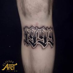 a man's lower leg with the word rock on it in black and grey ink