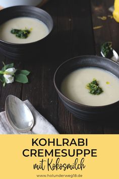 two bowls filled with soup on top of a wooden table