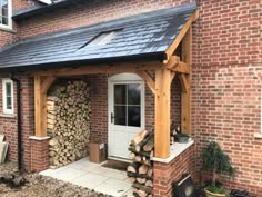 a house with wood stacked on top of it